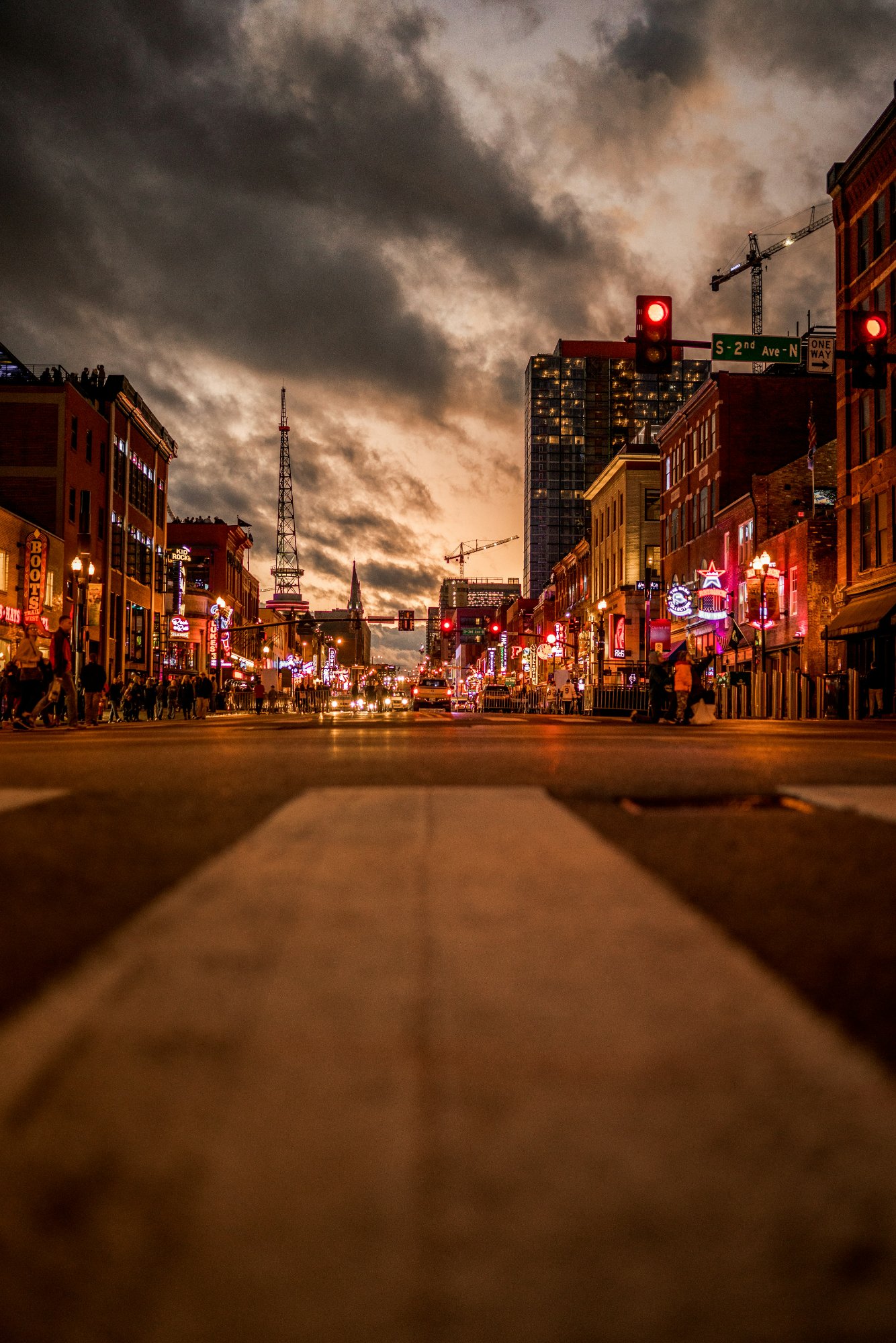 Lower Broadway in Nashville at sunset with neon signs and live music venues